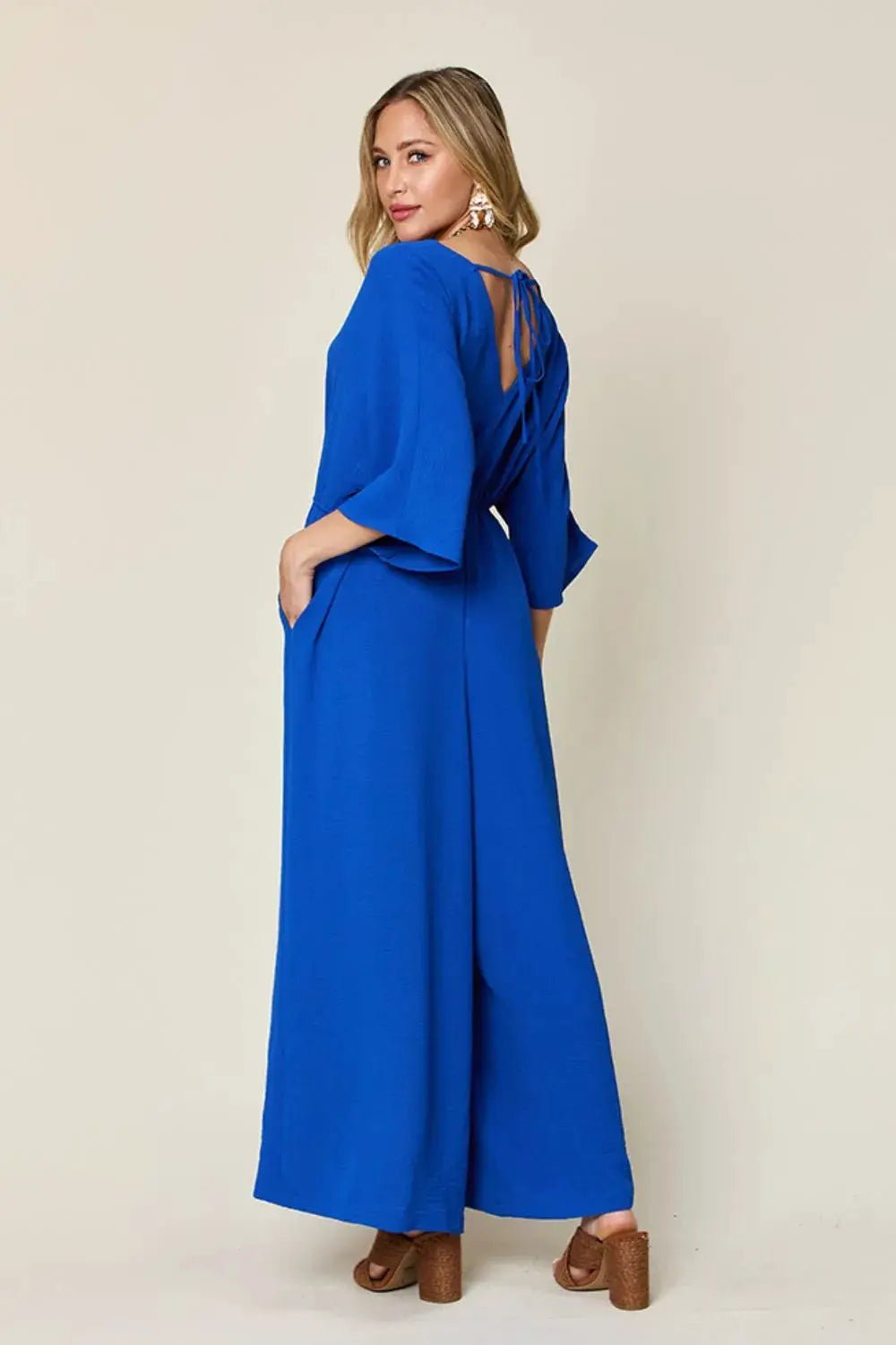 Double Take Surplice Wide Leg Jumpsuit With Pockets Full Size - Fritsch & Co.